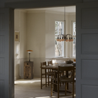 The PH 1/1 Chandelier, 6-Light by Louis Poulsen in a dining room turned off.