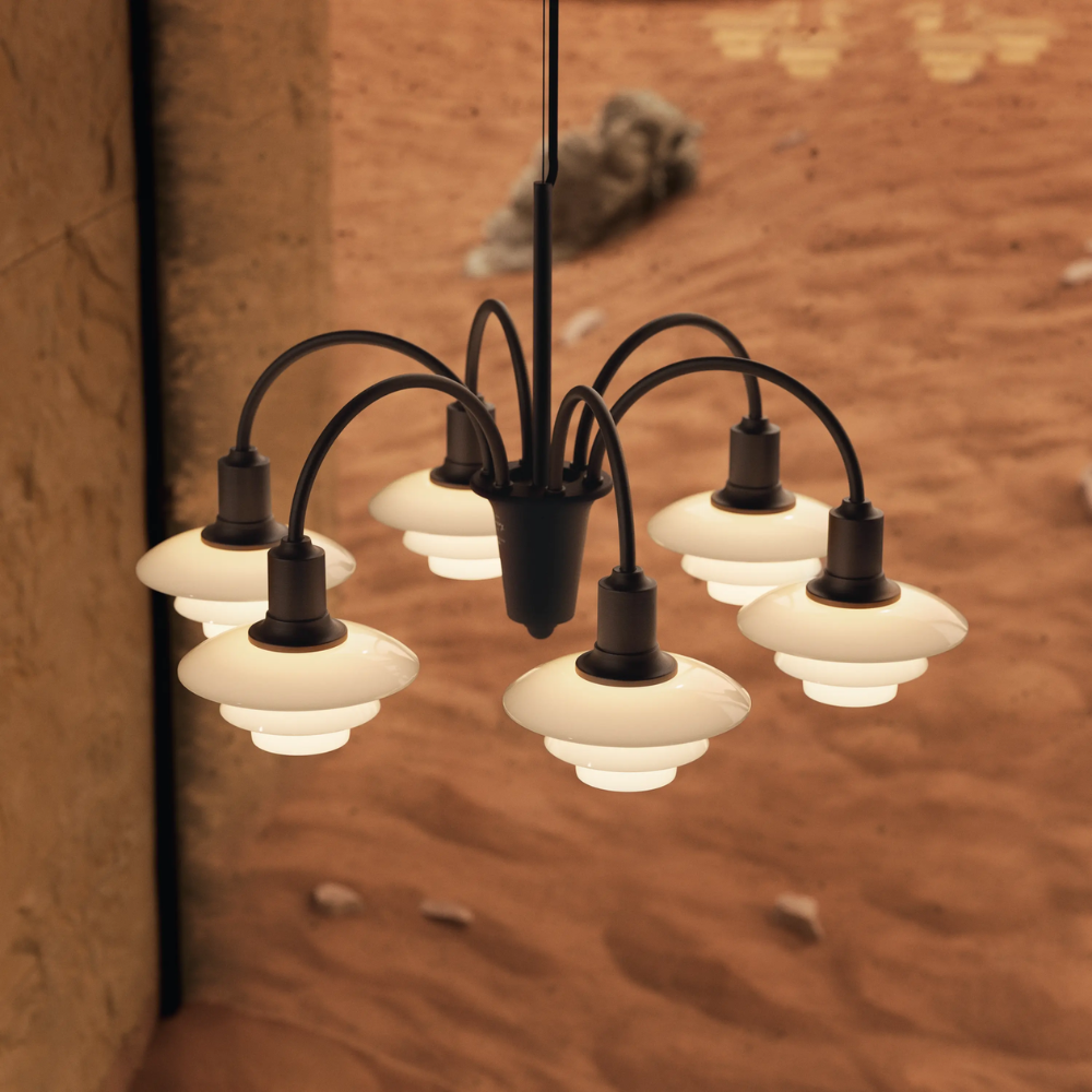 Campaign photo of the PH 1/1 Chandelier, 6-Light by Louis Poulsen turned on.