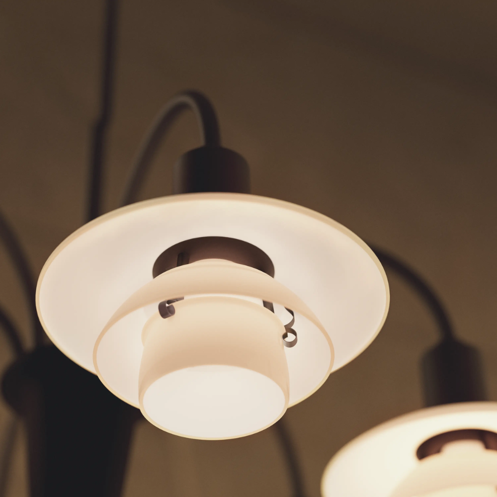 Detailed image of the PH 1/1 Chandelier, 6-Light by Louis Poulsen turned on.
