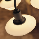 Detailed image of the shade of PH 1/1 Chandelier, 9-Light by Louis Poulsen turned on.