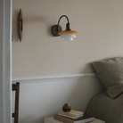 PH 2/2 Wall Lamp Centenary Edition with switch in bedroom turned on.