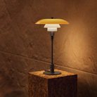The PH 3/2 Table Lamp Centenary Edition by Louis Poulsen turned on.