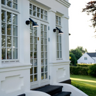 The AJ 50 Wall from Louis Poulsen outside lighting up stairs.