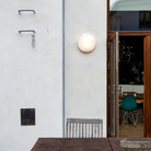 The AJ Eklipta Outdoor from Louis Poulsen in an outdoor dining space. all-groups