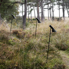 The AJ Garden Bollard from Louis Poulsen in a backyard.