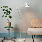 The NJP Floor Lamp from Louis Poulsen in a lounge lifestyle photograph.