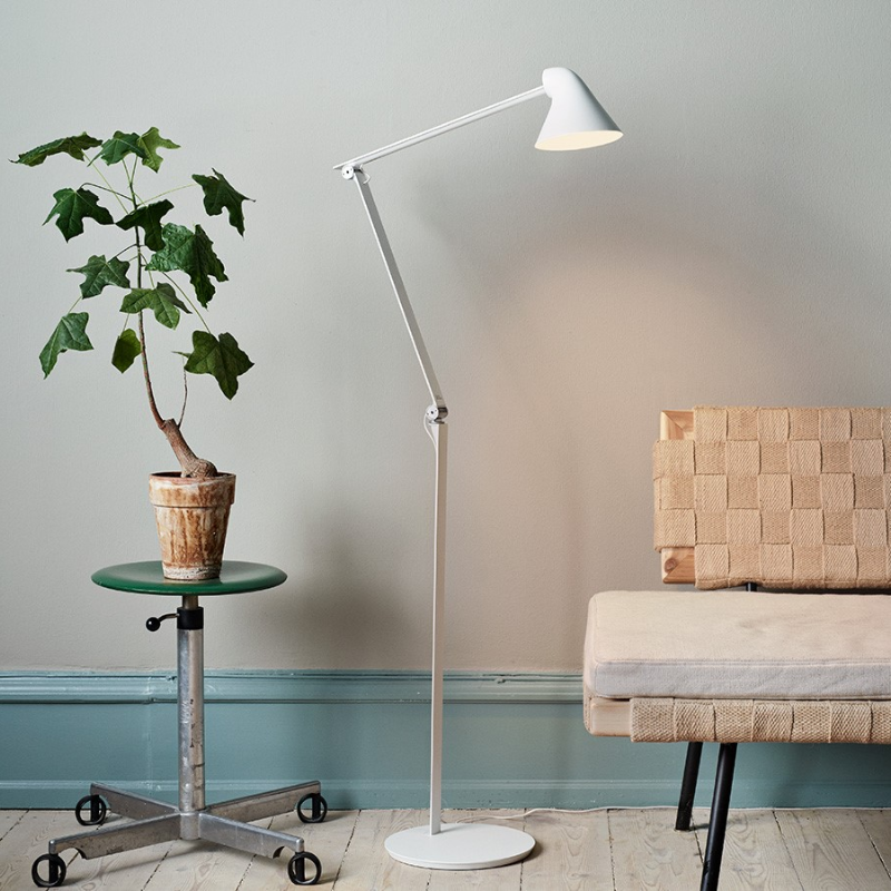 The NJP Floor Lamp from Louis Poulsen in a lounge lifestyle photograph.