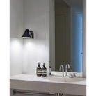The NJP Wall from Louis Poulsen within a bathroom.