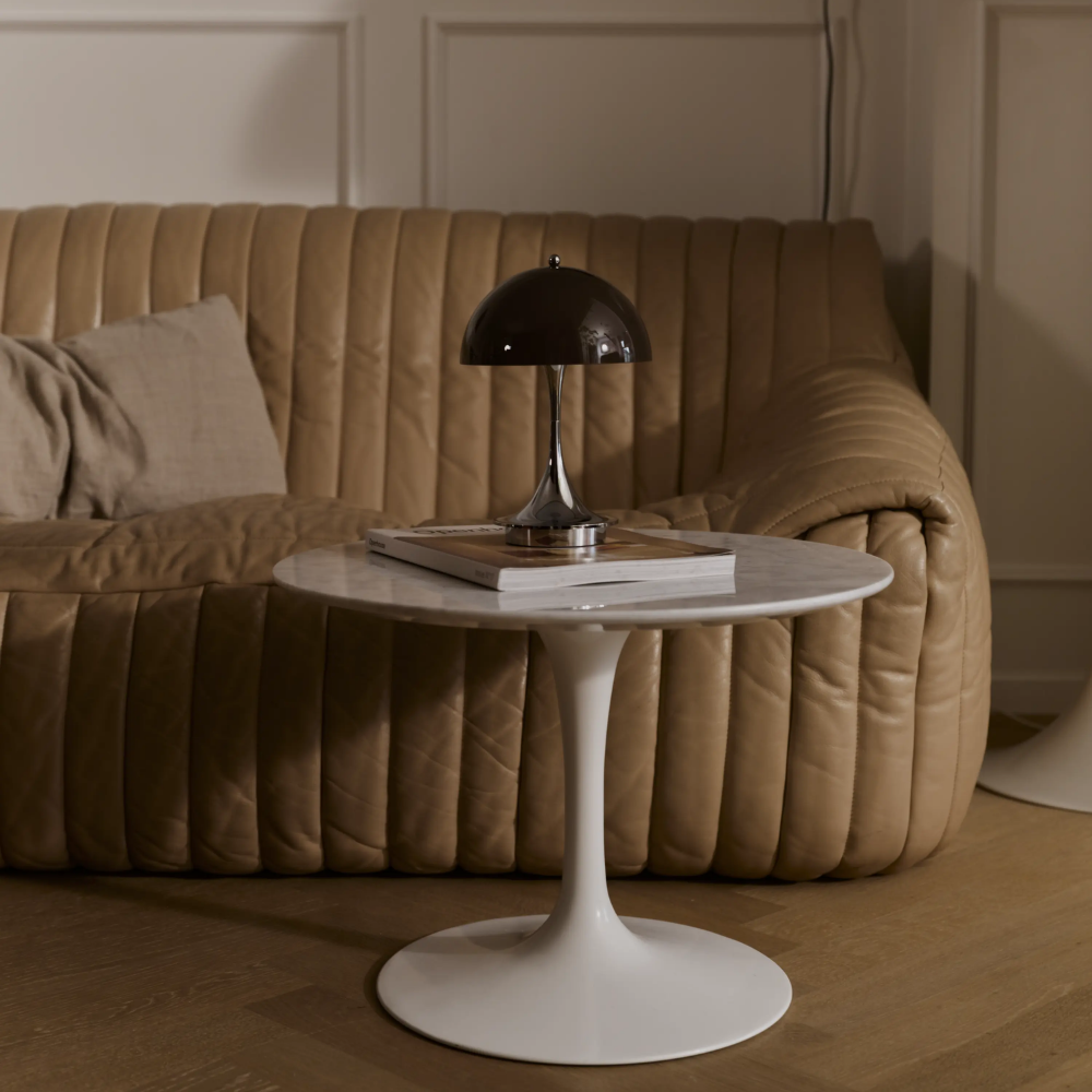 The Panthella 160 Portable Lamp from Louis Poulsen in Original Opal Brown in a living room turned off.