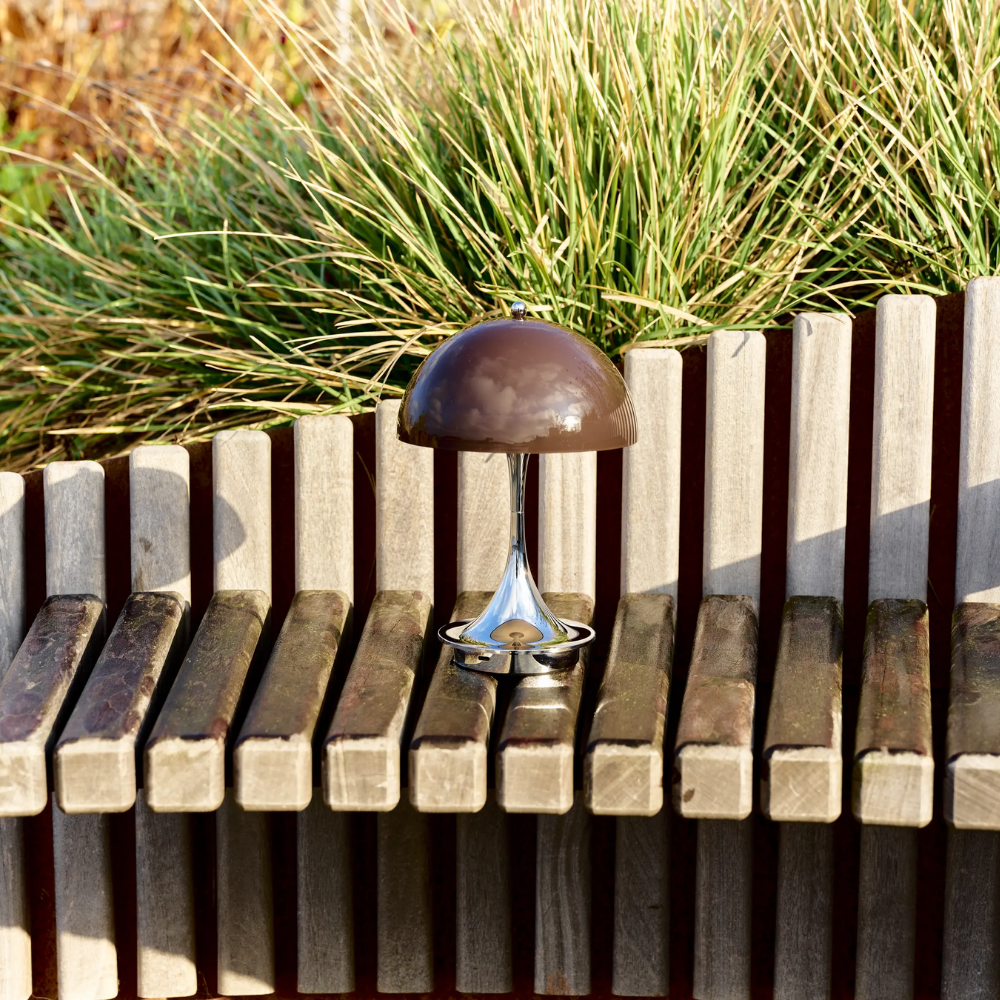 The Panthella 160 Portable Lamp from Louis Poulsen in Original Opal Brown outside.