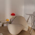 The Panthella 160 Portable Lamp from Louis Poulsen in Original Opal Orange in a living room.
