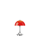 The Panthella 160 Portable Lamp from Louis Poulsen in Original Opal Red turned on.