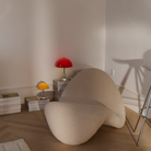 The Panthella 250 Portable Table Lamp from Louis Poulsen in Original Opal Red  in a living room.