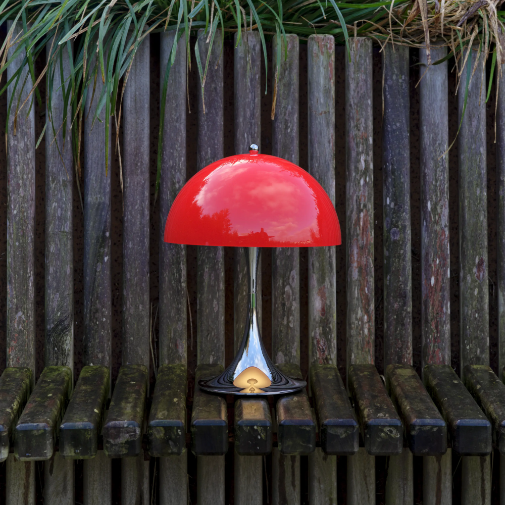 The Panthella 250 Portable Table Lamp from Louis Poulsen in Original Opal Red outside.