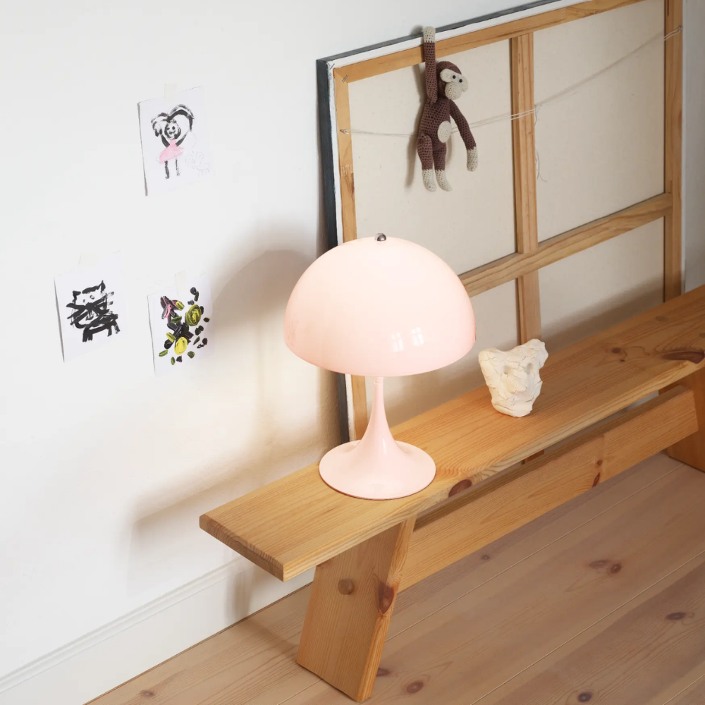 The Panthella 250 Portable Table Lamp from Louis Poulsen in Opal Pale Rose in a child's bedroom.