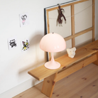 The Panthella 250 Portable Table Lamp from Louis Poulsen in Opal Pale Rose in a child's bedroom.