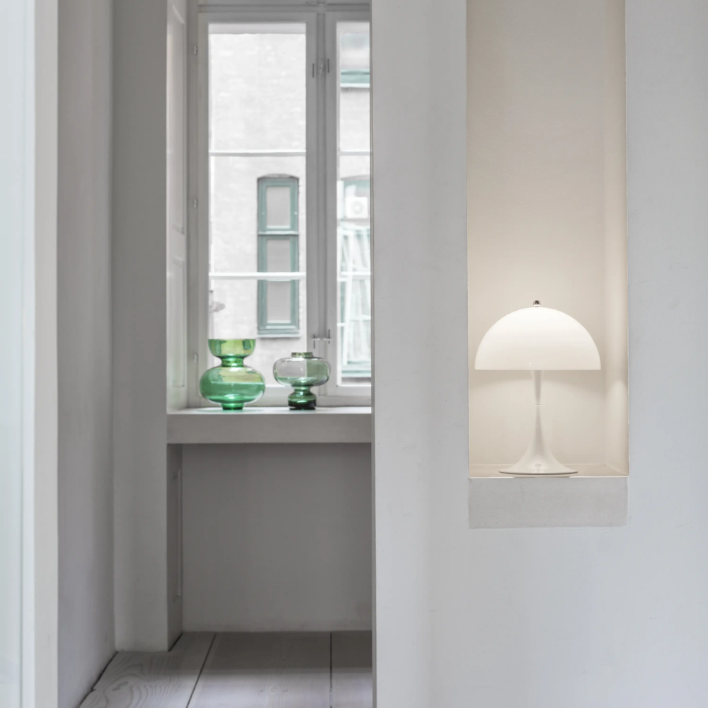 The Panthella 250 Portable Table Lamp from Louis Poulsen in Opal white in a niche.