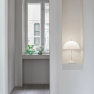 The Panthella 250 Portable Table Lamp from Louis Poulsen in Opal white in a niche.