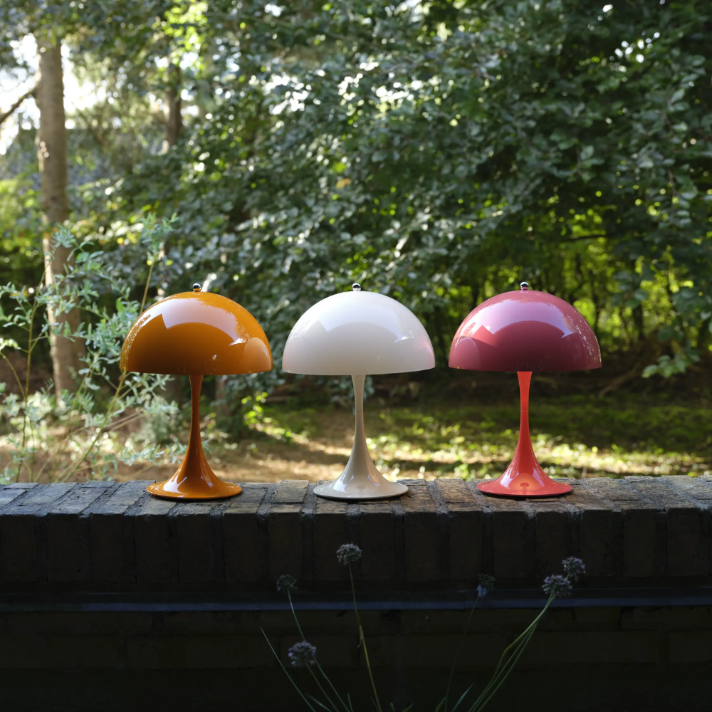 The Panthella 250 Portable Table Lamp from Louis Poulsen in Orange, Opal Beige, and Coral.
