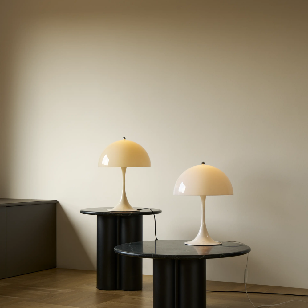 The Panthella 320 Table Lamp from Louis Poulsen in Opal Beige and Opal White turned on.