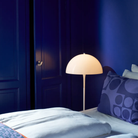 The Panthella 400 Floor Lamp by Louis Poulsen in. a bedroom.