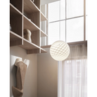 The Patera Pendant from Louis Poulsen in a bedroom.