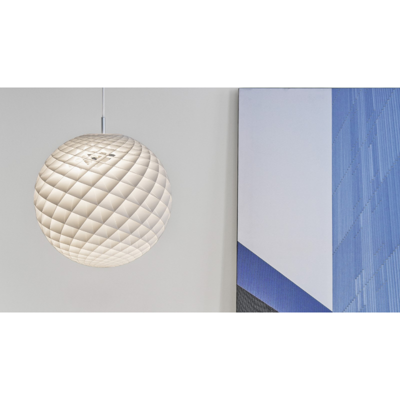 The Patera Pendant from Louis Poulsen in a living room.