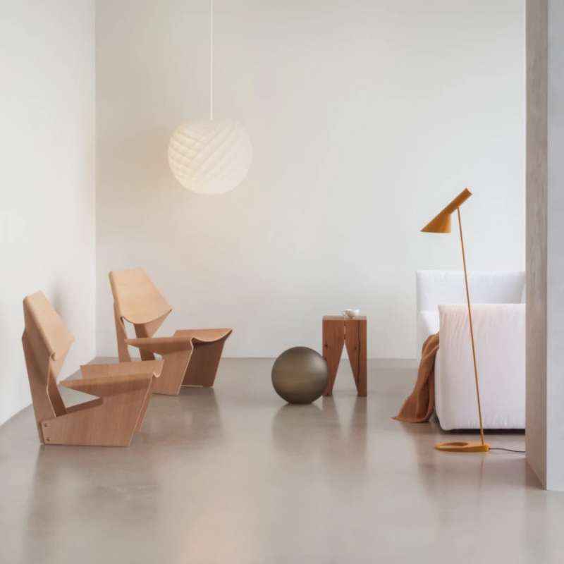 The Patera Pendant from Louis Poulsen in a lounge lifestyle photograph.