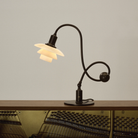 The PH 1/1 Piano Table Lamp by Louis Poulsen on a piano.