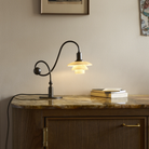 The PH 1/1 Piano Table Lamp by Louis Poulsen on a credenza.