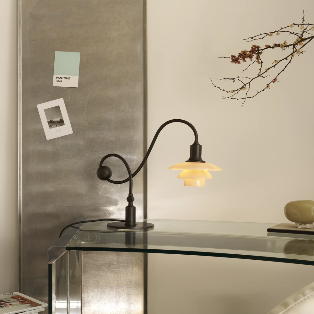The PH 1/1 Piano Table Lamp by Louis Poulsen on a table.