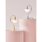 The PH 2/2 Question Mark Chrome Table Lamp from Louis Poulsen in a photograph of the Question Mark collection, alongside the Pale Rose option. all-groups