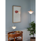 The PH 2/2 Question Mark Chrome Table Lamp from Louis Poulsen in a family area.