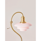 The PH 2/2 Question Mark Pale Rose Table Lamp from Louis Poulsen in a living room.