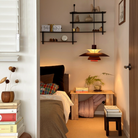 The PH 5 from Louis Poulsen in monochrome burgundy as a bedside light.