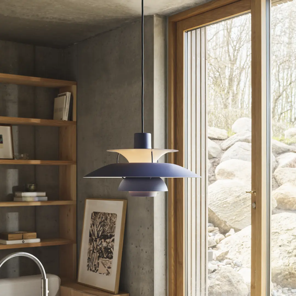 The PH 5 from Louis Poulsen in monochrome dusty indigo in a kitchen.