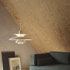The PH 5 from Louis Poulsen in monochrome pale pewter in a living room turned on.