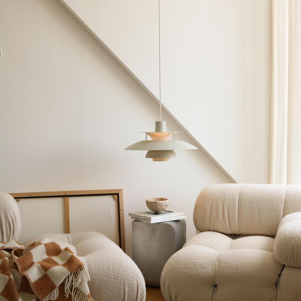 The PH 5 from Louis Poulsen in monochrome pale pewter in a living room.