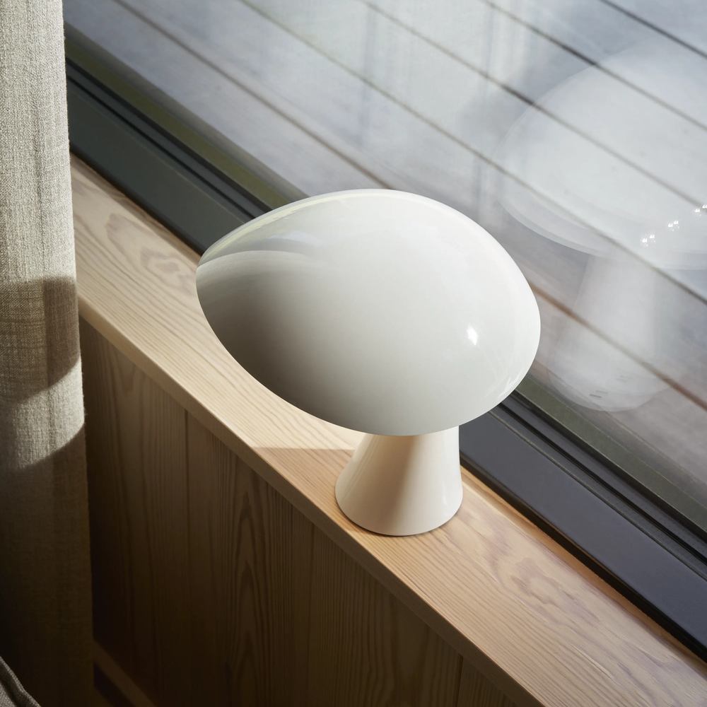 Rumee 220 Portable Lamp in Cloud White in a windowsill.