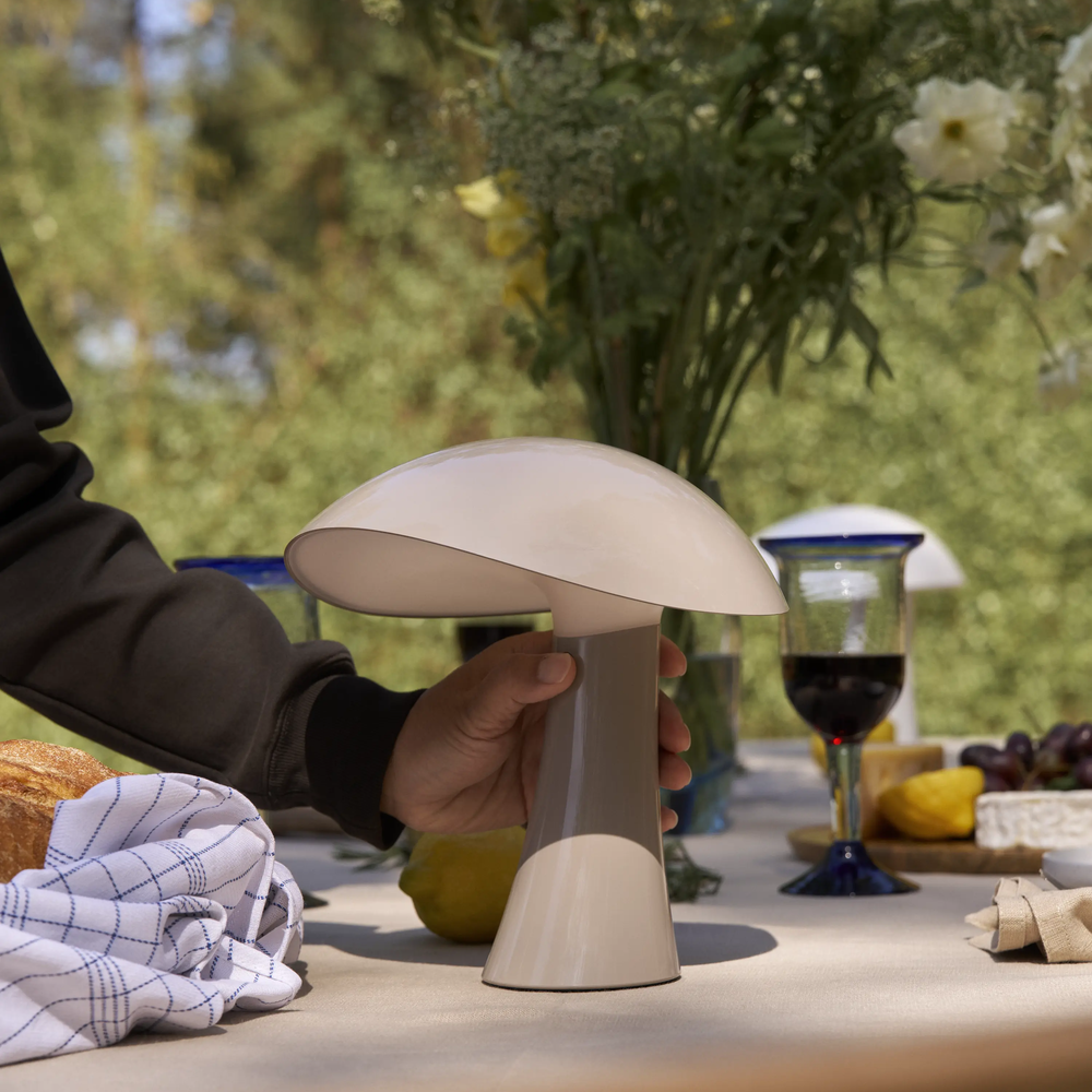 Rumee 220 Portable Lamp in Earth Grey being turned on.