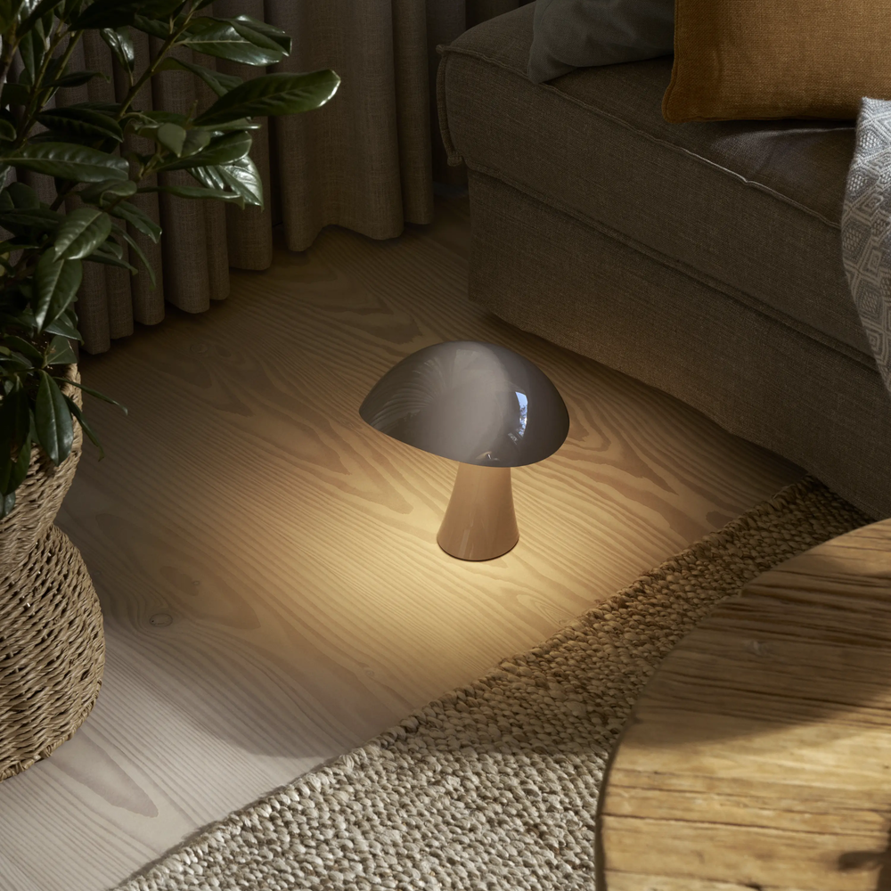 Rumee 220 Portable Lamp in Earth Grey being used on a living room floor.