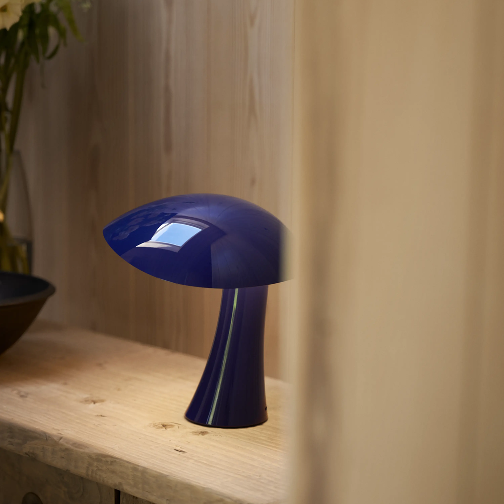 Rumee 220 Portable Lamp in Night Blue on a ledge.