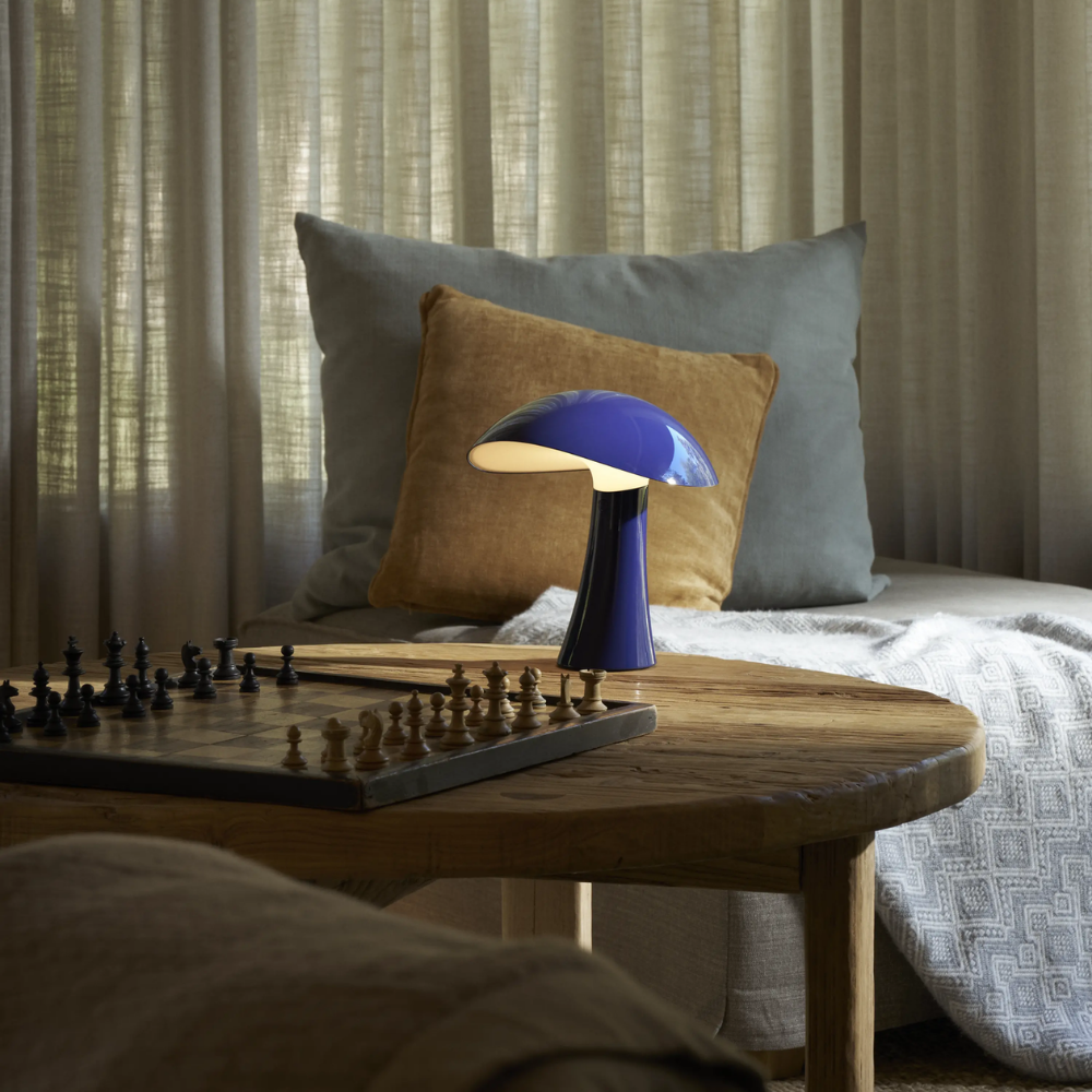 Rumee 220 Portable Lamp in Night Blue in a living room.