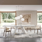 The Lita Pendant by Luceplan, 11.8-inch  pendants in matte white over dining room table.