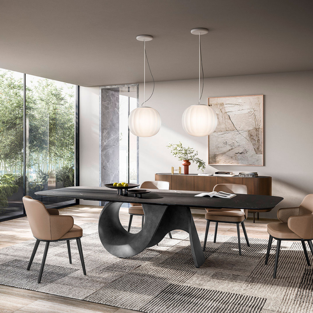 The Lita Pendant by Luceplan, 16.5-inch  pendant in matte white over a dining table.