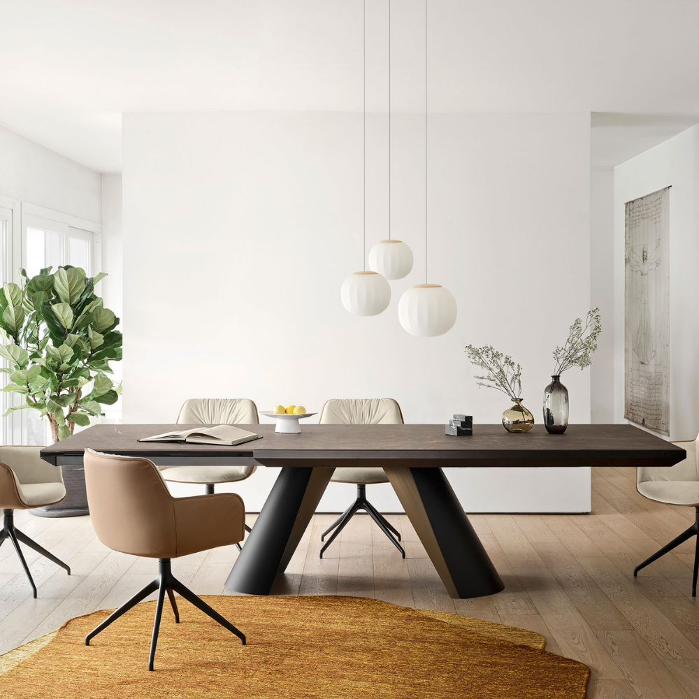 The Lita Pendant by Luceplan, 7-inch and 11.8 inch pendants in ash wood over a dining table.