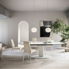 The Lita Pendant by Luceplan, 11.8-inch  pendants in matte white over a dining room table.
