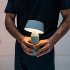 The Bicoca Portable Table Lamp from Marset in off-white in a home office.