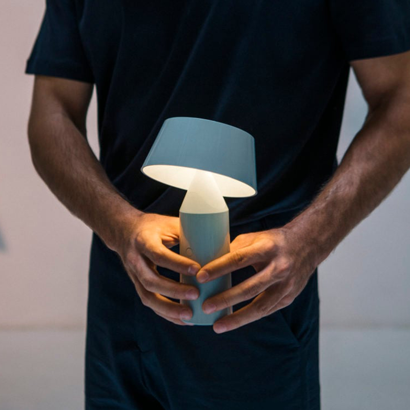 The Bicoca Portable Table Lamp from Marset in off-white in a home office.