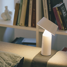 The Bicoca Portable Table Lamp from Marset in off-white in a lounge.